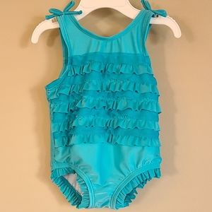 Blue one piece swimsuit with front ruffles